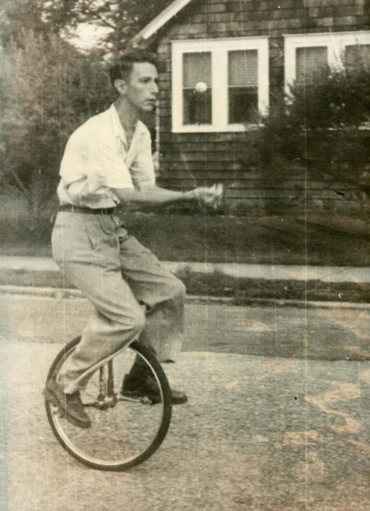 Claude Shannon juggling while riding a unicycle, a photo from his years at Bell Labs